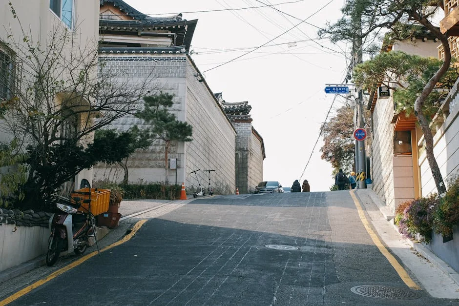Seongsu-dong industrial corridor at mid-afternoon, brick warehouse facades and rebar mezzanines along Yeonmujang-gil, spring Seoul.