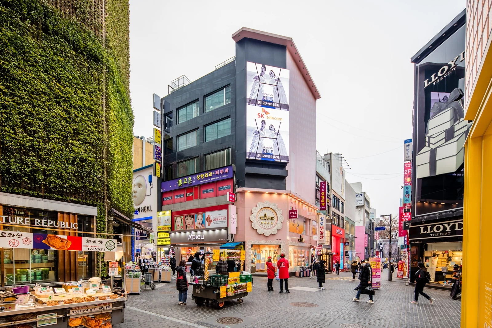 Yeonnam-dong cafe corridor in late-spring morning light, low-rise brick facades and the Gyeongui Line Forest Park rail-bed pavement.